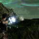 A woman wielding magic prepares to fight creatures in a field of grass.